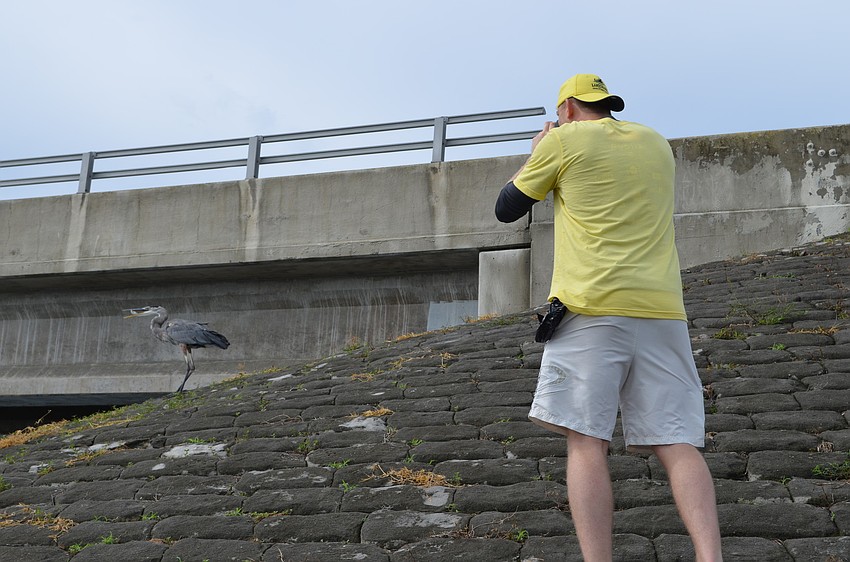 Jon Pierce takes a break from collecting trash to capture some wildlife on film.