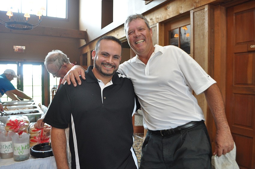 Odgen Clark, community outreach director for Habitat for Humanity, poses with Menâ€™s Club President Pierre Schutte.