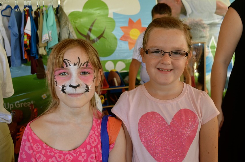 Kaylee Burns shows off her face paint beside her friend, Adriana Stanzione.