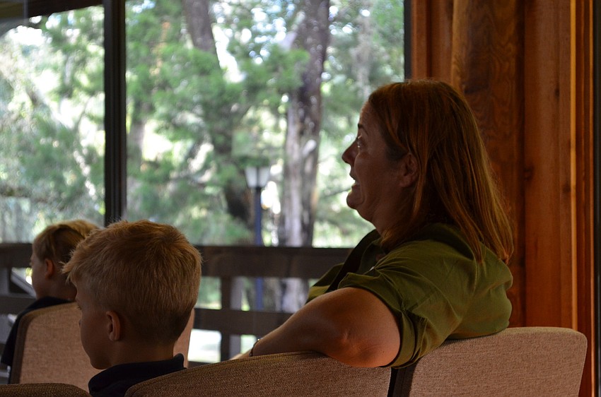Out of Door Academy teacher Kelly Raggo pays attention during the â€œHoward B. Wigglebottom Learns to Listenâ€ presentation.