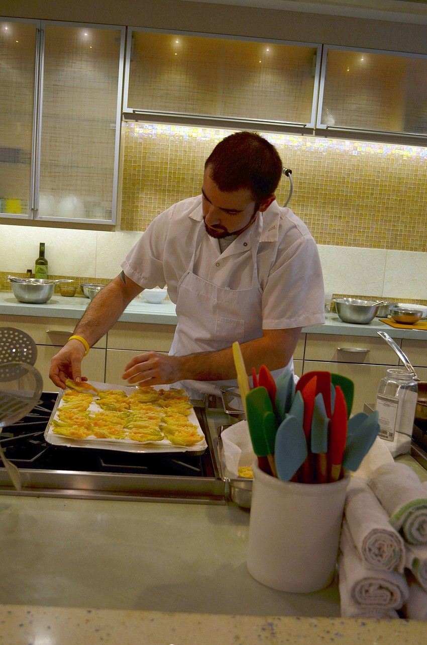 Michael Houser prepares food for the Maison Blanche Farm to Fork dinner.