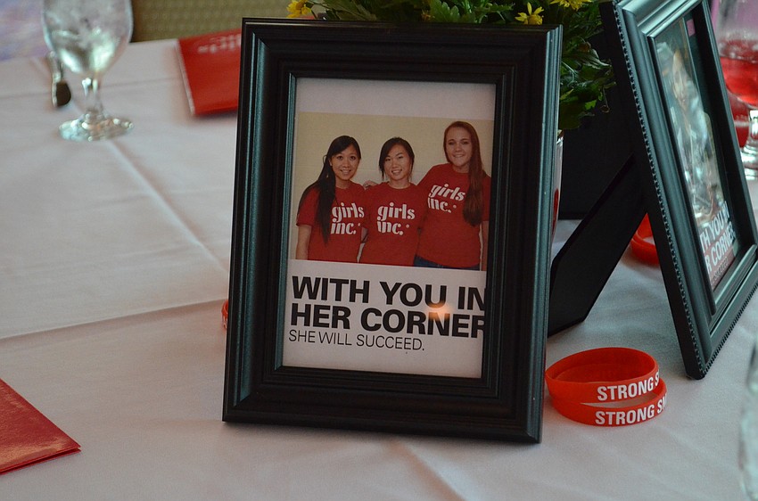 Framed photos of students involved in Girls Inc. were placed on every table.