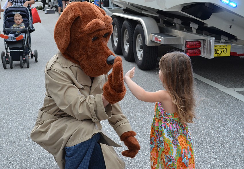 Kensley Lamb gives Scruff McGruff a high-five.