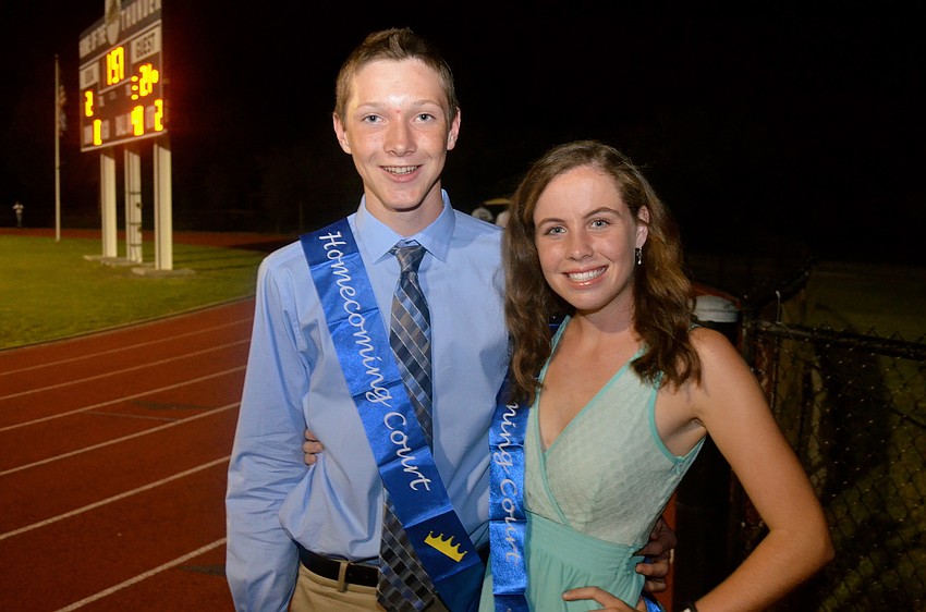 Sophomore prince and princess Brady Moore and Carling Landeche hang out on the field.