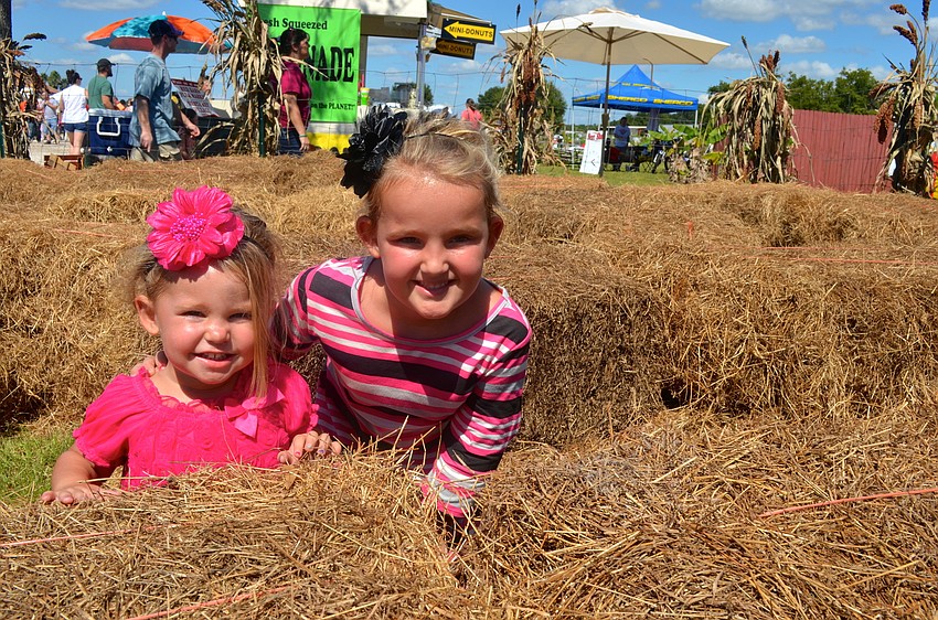 Makenzie and Hallie Sorrells play in the hay maze.
