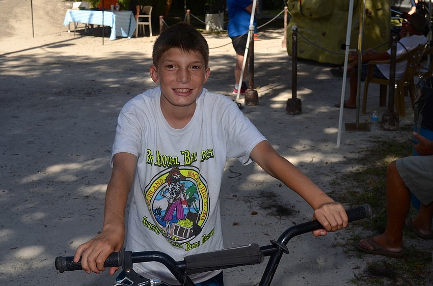 Jonah Nuzzo rides his bicycle around the event.