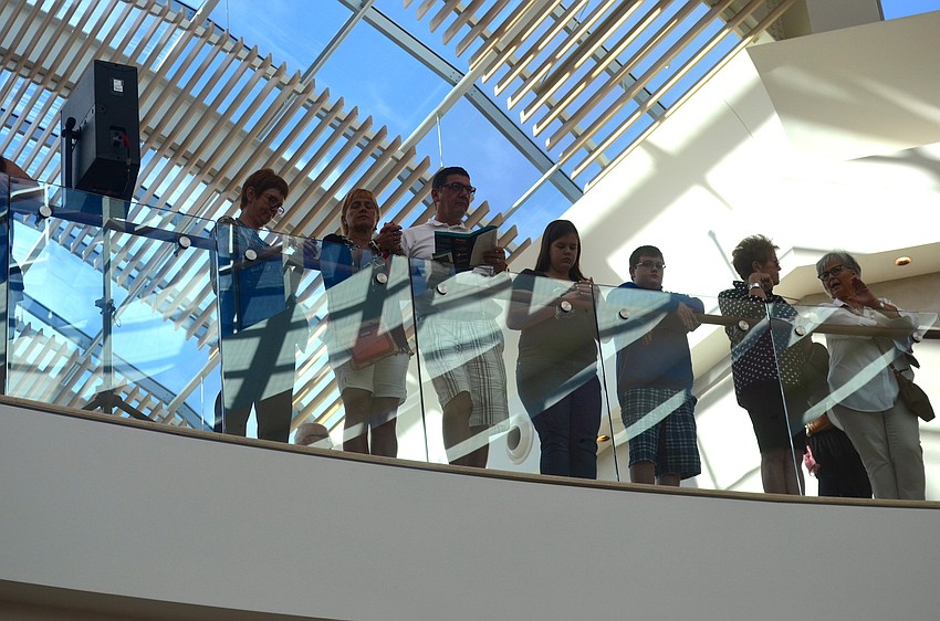 Shoppers watch the opening ceremony from the second floor.