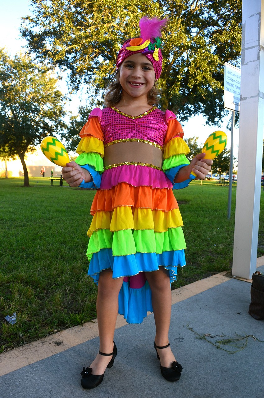 Alexis Rissler makes music as part of her costume.