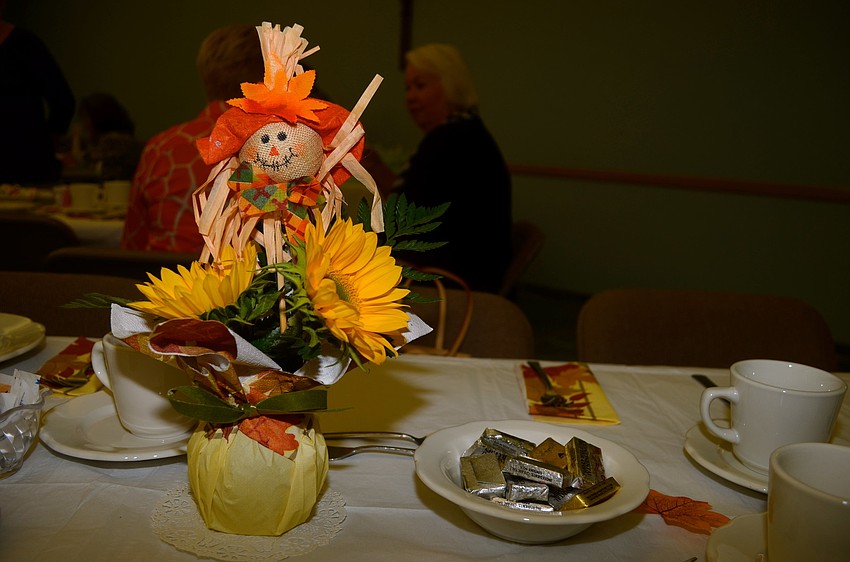 Fall centerpieces decorate each table.
