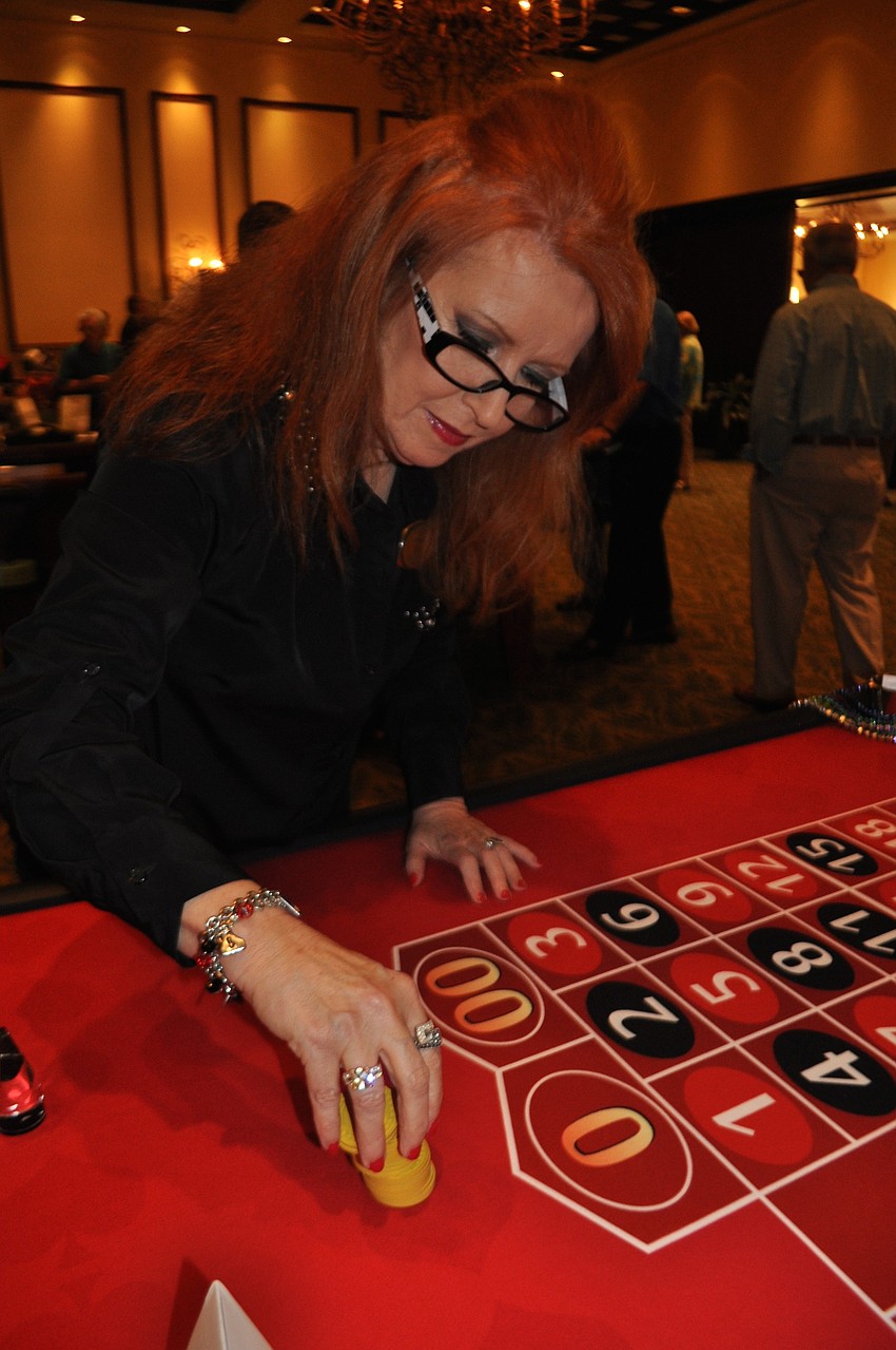 Bett Walbrecht deals for a game of roulette.