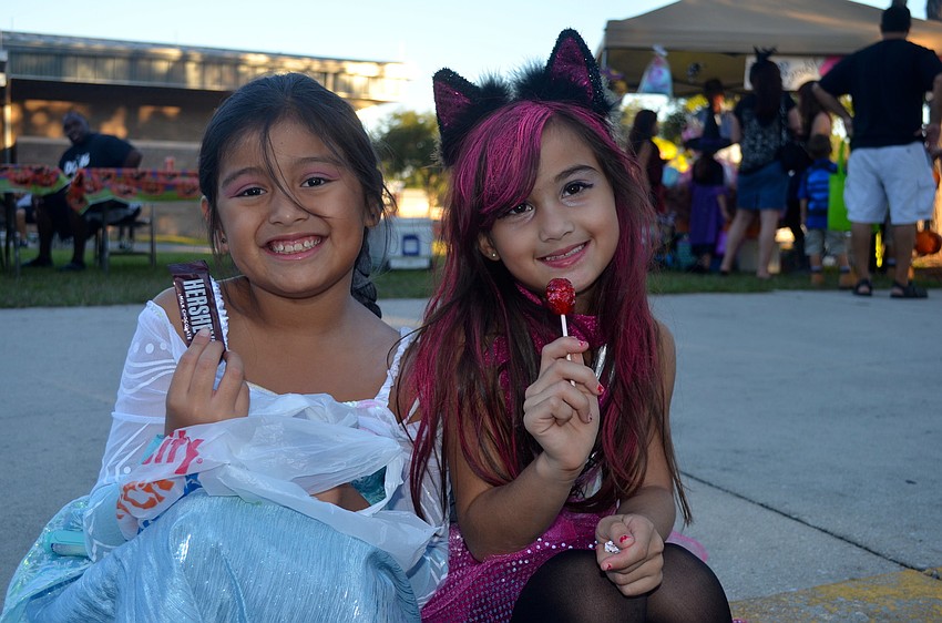 Friends Izabella Detoma and Alyssa Youssef snack on candy.