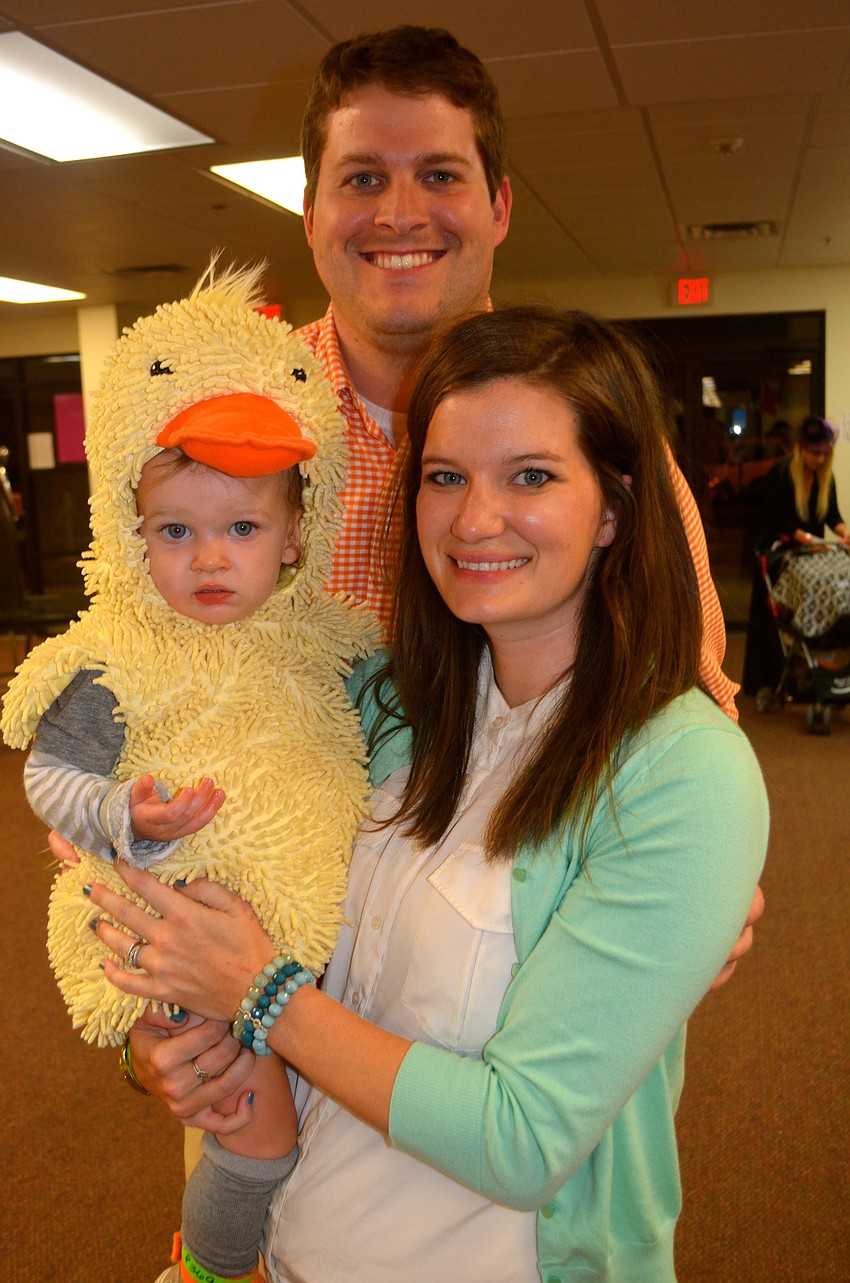 Winslow Jones sports a duck costume, beside his mother, Kaitlin, and his father, Seth.