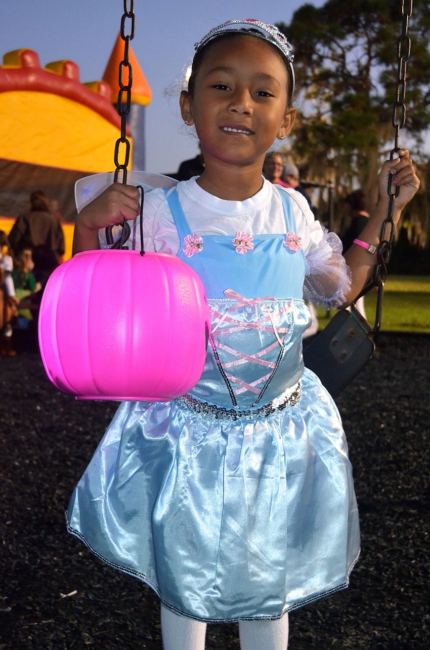 Nyla Mendoza plays on the swing set with her candy in hand.