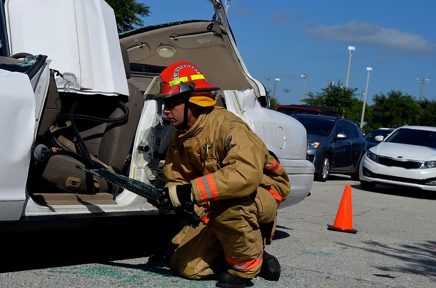 Lieutenant Casey Lambert cleans up after a car extraction demonstration.
