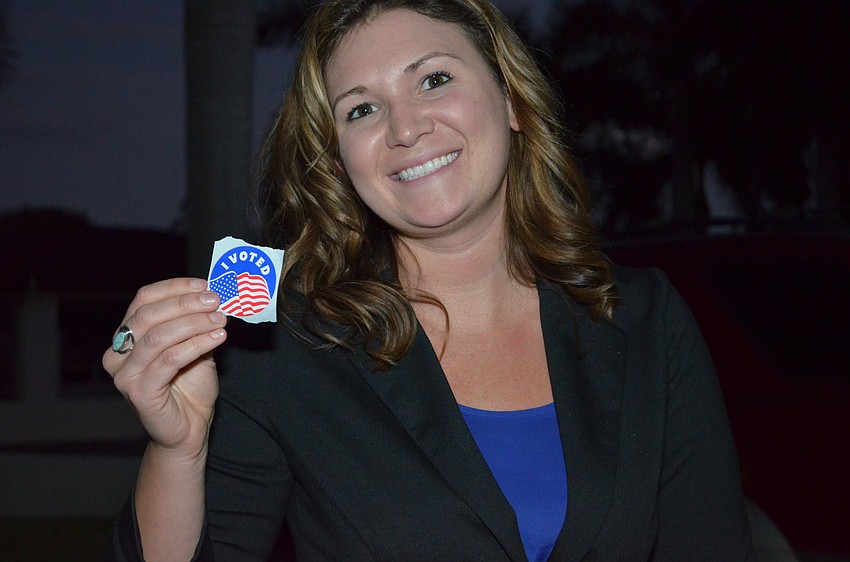 Jenna Quade shows off her sticker after voting.