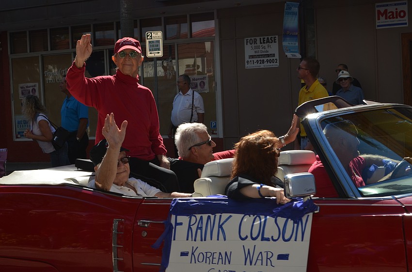 Korean War veteran Frank Colson rides along during the Veterans Day Parade.