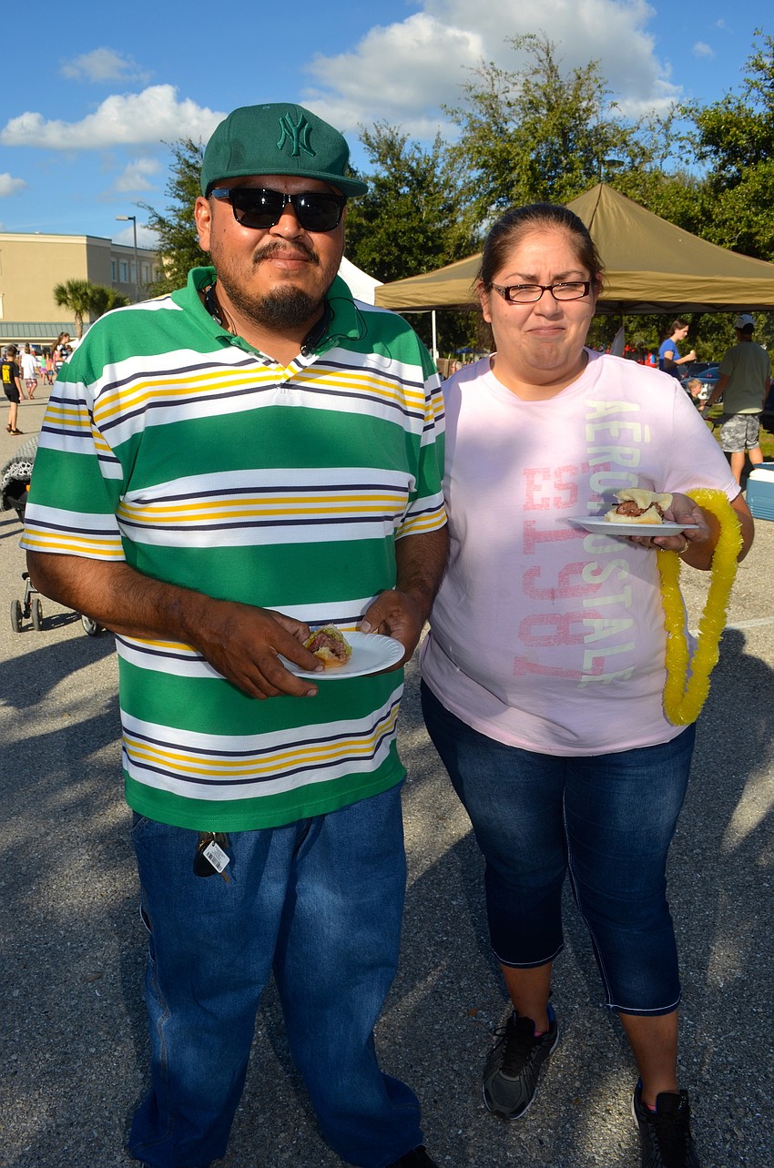 Eriverto Ramirez and Natalia Rangel taste test burgers at the event.