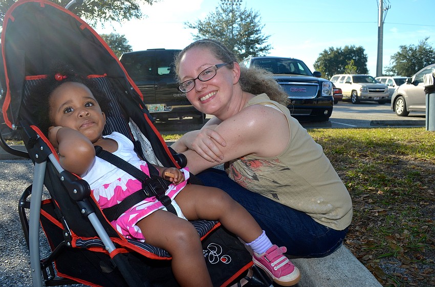 Lauryn Blue and her mother, Sarah, rest in the shade.