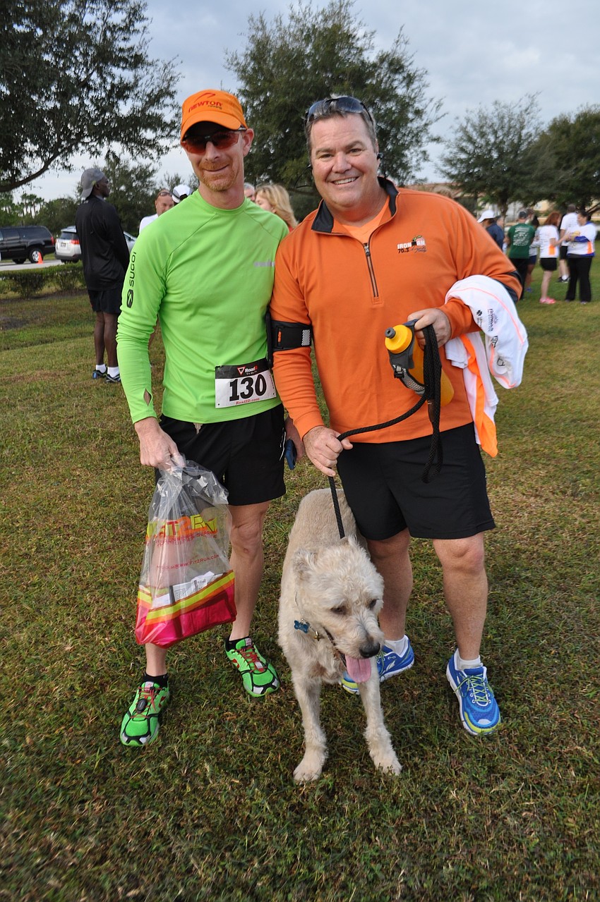 Tom Egan stands with Tommy Klauber and his dog, Levi, who sets the pace.