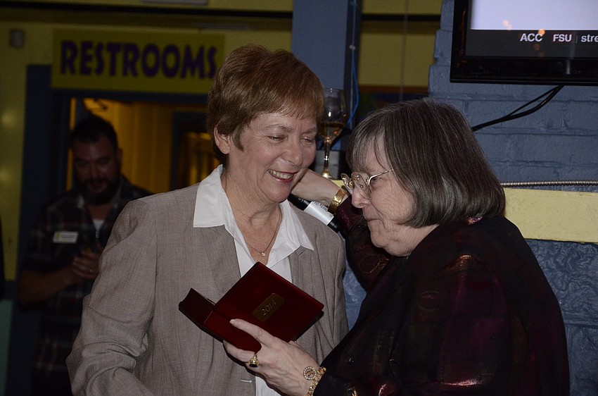 Nora Patterson receives a gift from Kafi Benz.