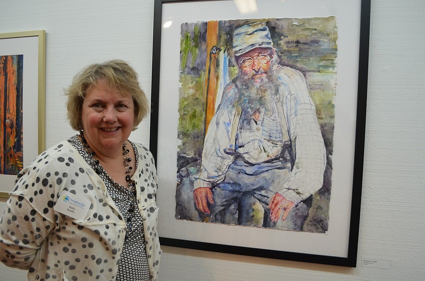Kathy Durdin, Florida Watercolor Societyâ€™s director of operations, poses with her watercolor titled â€œBowleg Creek.â€