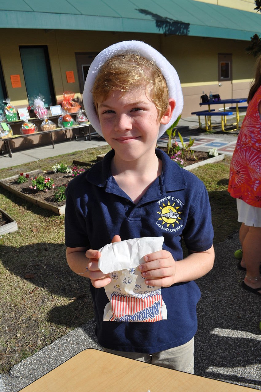 Second-grader Campbell Lawless sells popcorn.