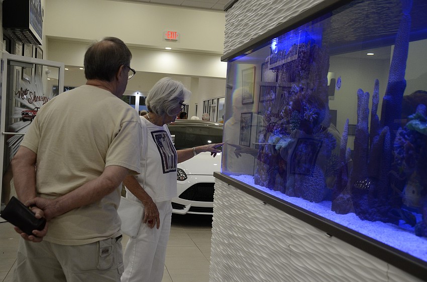 Dan and Mariette Favre admire the fish inside the aquarium at Sarasota Ford.