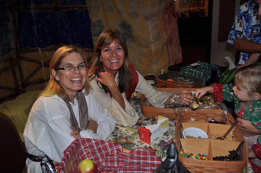 Janice Pinsonneault and Kelly Pleasant dish out nuts and other snacks.