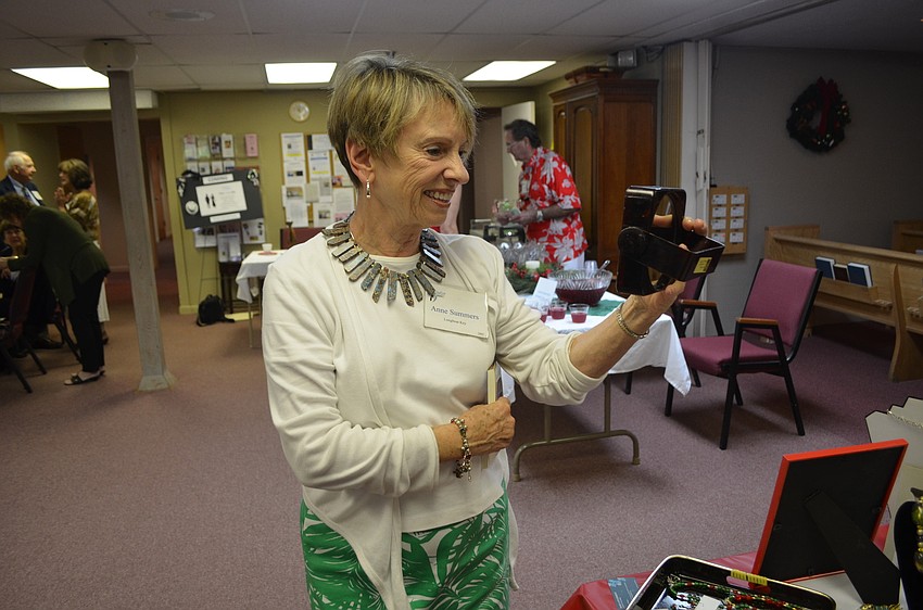 Anne Summers admires a necklace for sale at the bazaar.