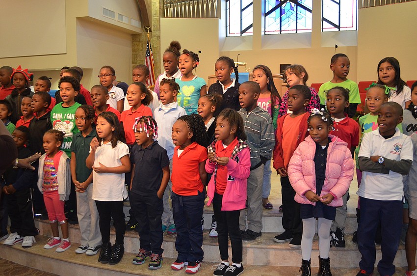The students sing Christmas carols to their buddies.