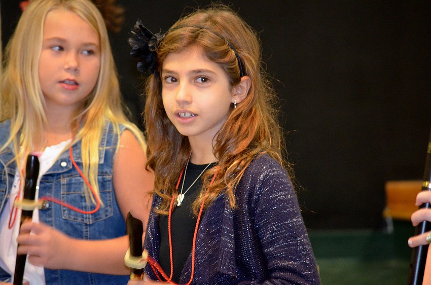 Liana Nesser waits for her cue from music teacher Marsha Juday.