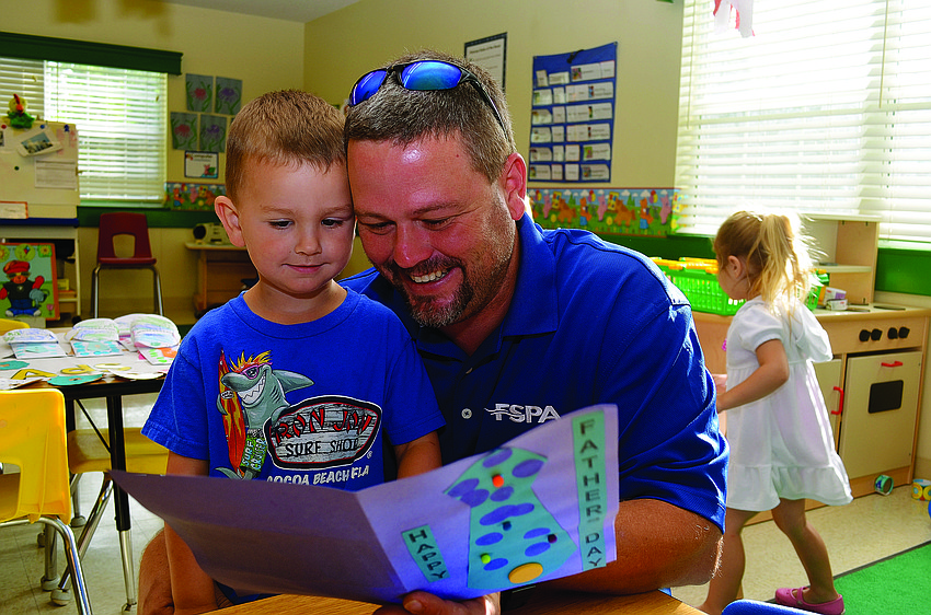 Cooper Mulder gives his father, Mark, his Father's Day gift at Primrose School at Lakewood Ranch.