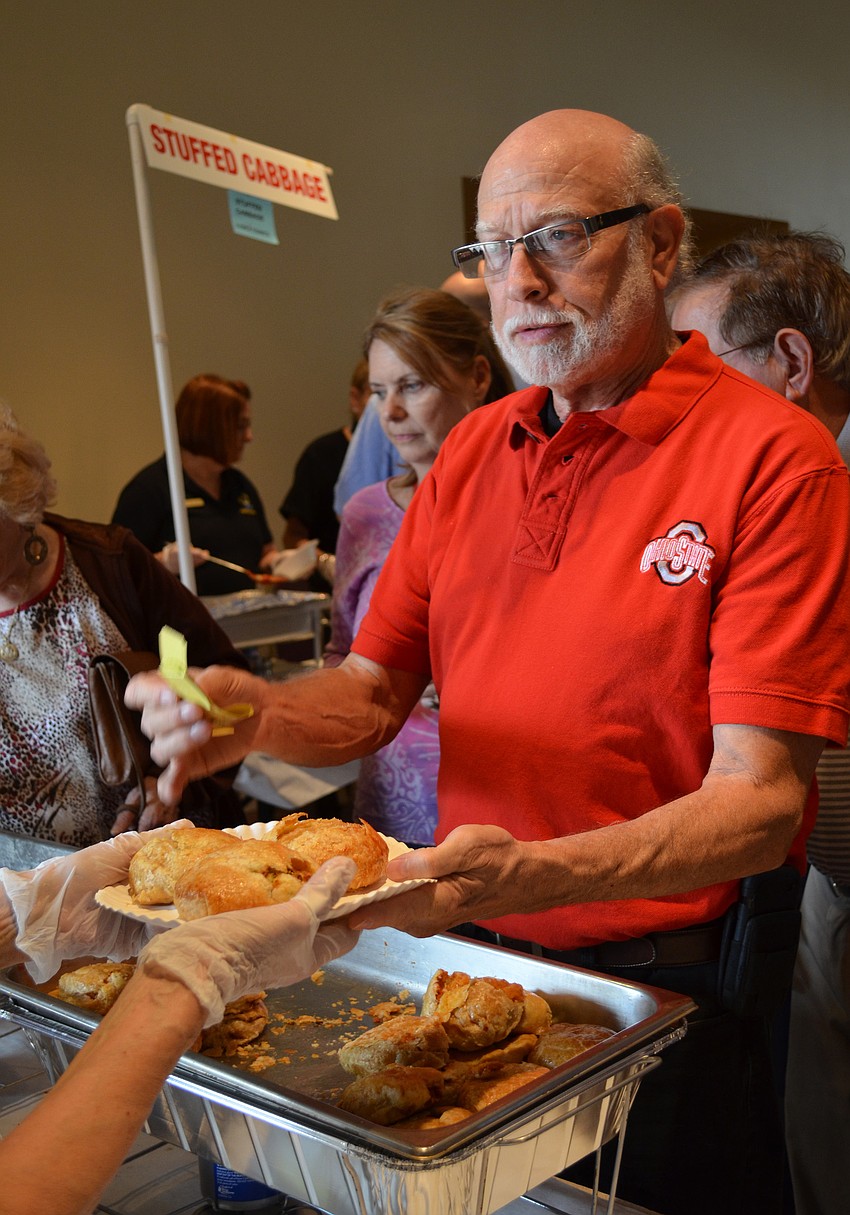 Rick Greene orders a few sweet potato and white potato knishes.