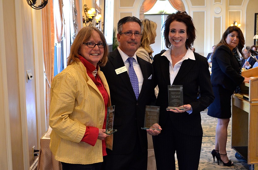 Former alliance board members Vicki Vega, Marc Simms and Teresa Tyrrell accept their awards for service.