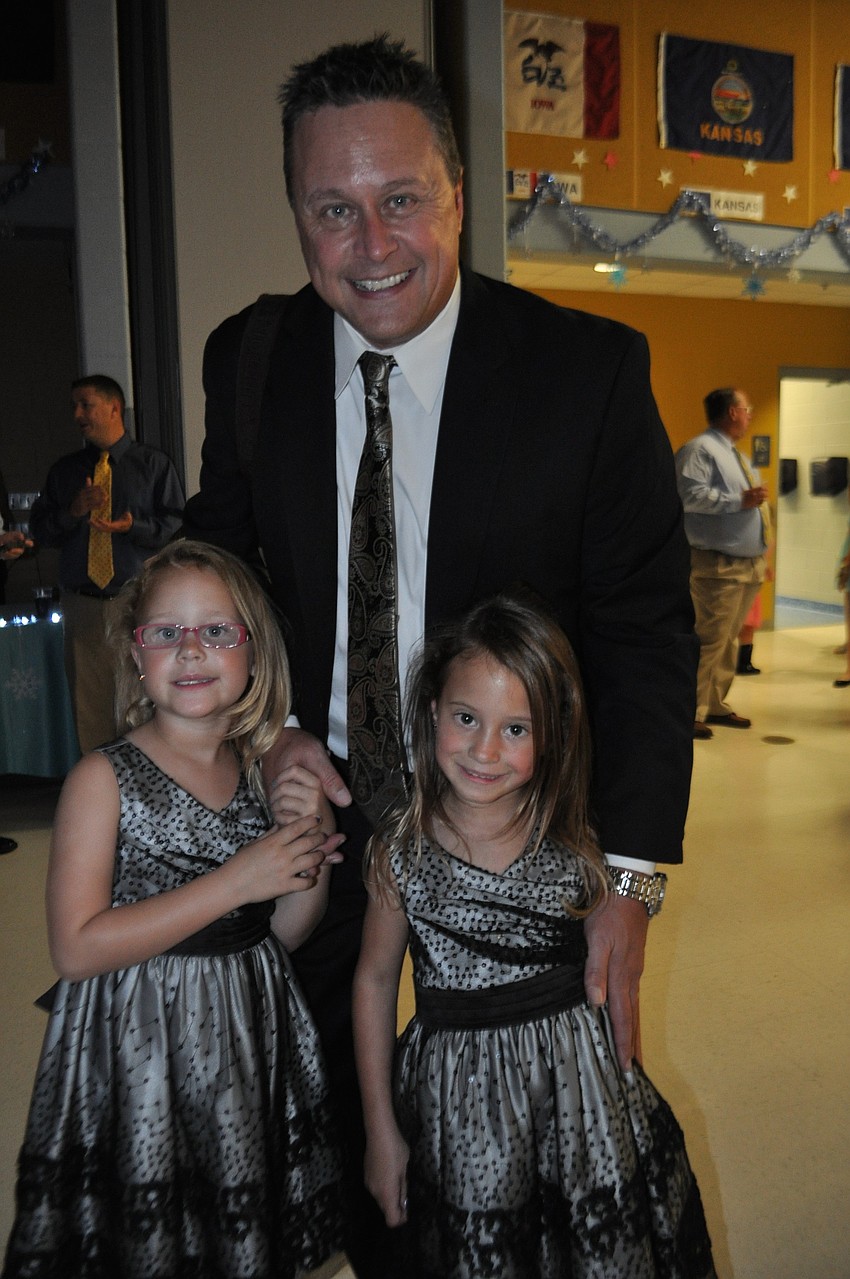 Jeff Seacat makes sure to dance with both his twin daughters, Jordyn, left, and Sydney, right.