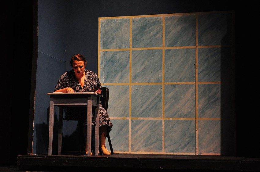 Zoe Kasper reads newspaper headlines as Mabel, Mr. Sorokin's busy-body secretary.