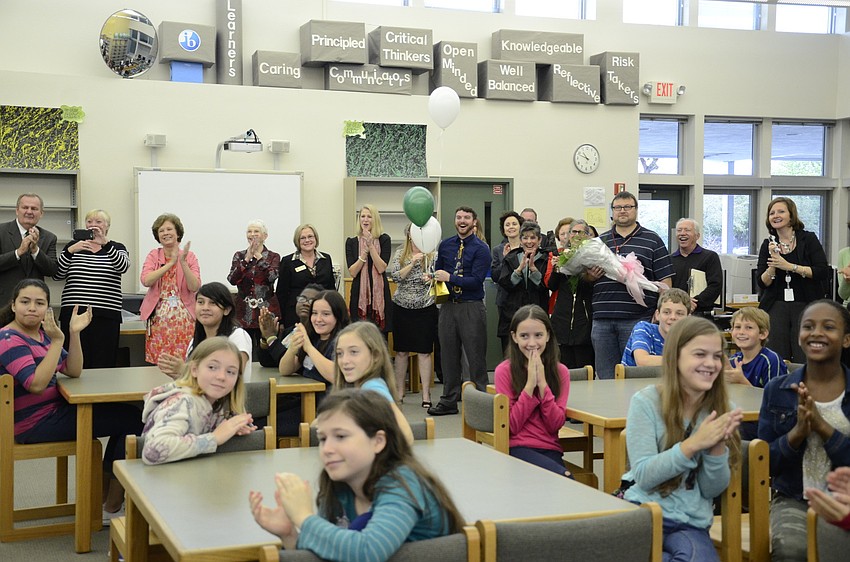 Students from Brookside Middle School and the award party cheer as Christi McDowell-Cameron accepts her award.