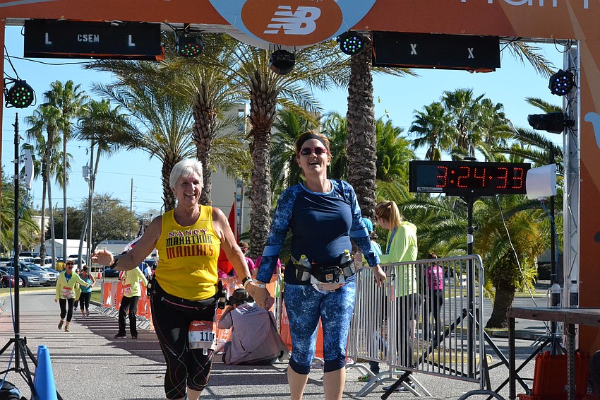 Mother and daughter Nancy Marino and Kim Lathbury cross the finish line together.