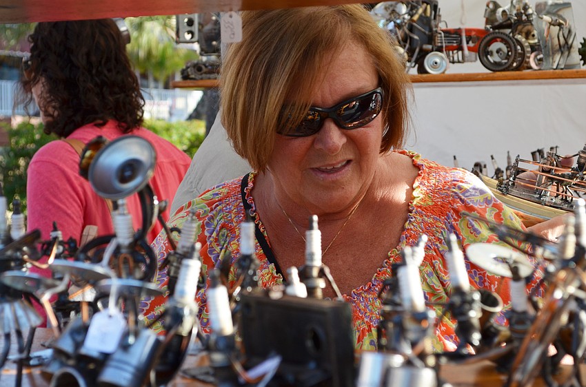 Aggie Hertel browses the selection of sculptures from Metal Sculptures by Dick Cooley.