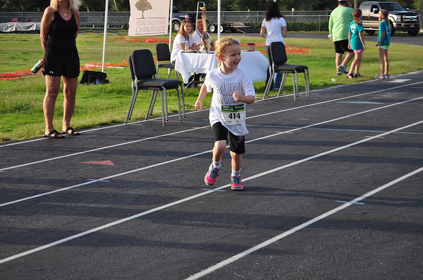 Emma Whitson, who turned 5 on May 4, looks back for her cheering dad, Charles, during a childrenâ€™s race.