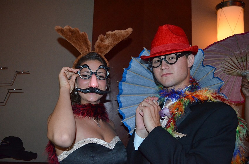 Zach McMullen and Emily Giuffre have fun at the photo booth.