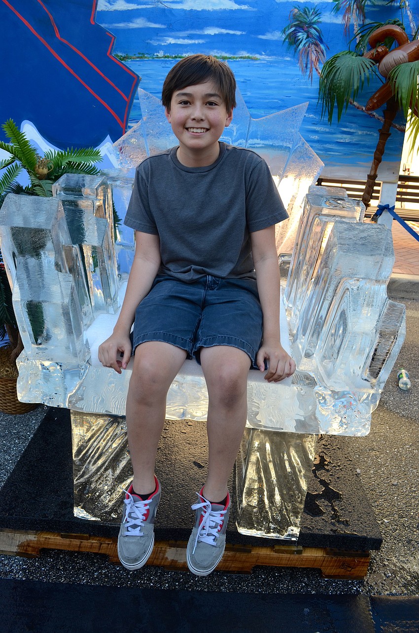Yoshi Torralba sits on a throne made of ice.