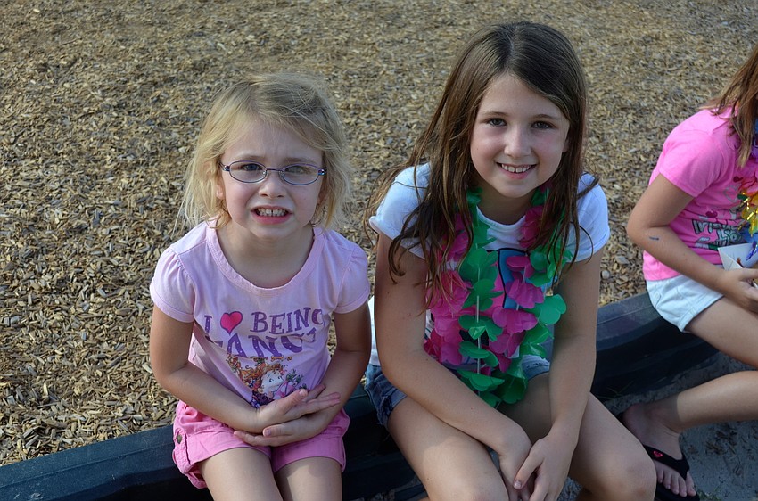 Sisters Madalyn and Makayla Miles spend time on the playground.