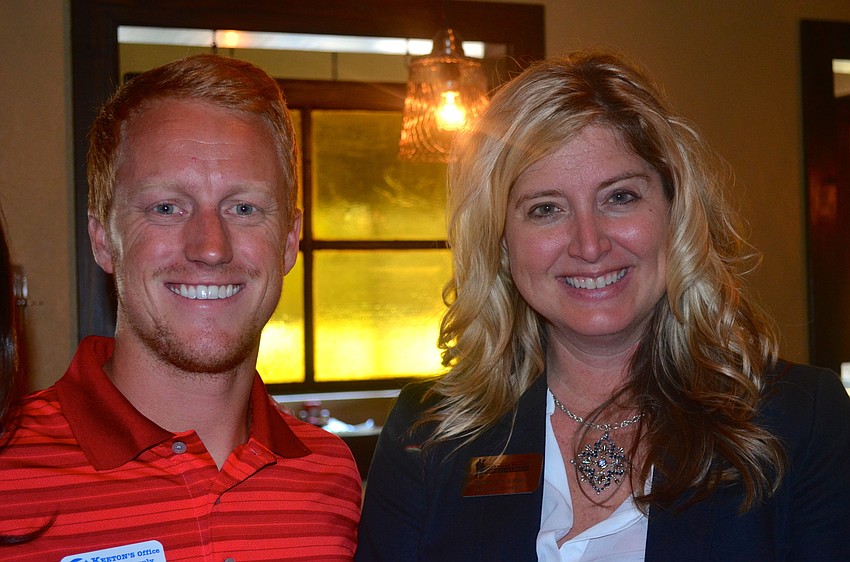 Jordan Hoopingarner makes friends with Business Alliance Executive Director Heather Kasten.