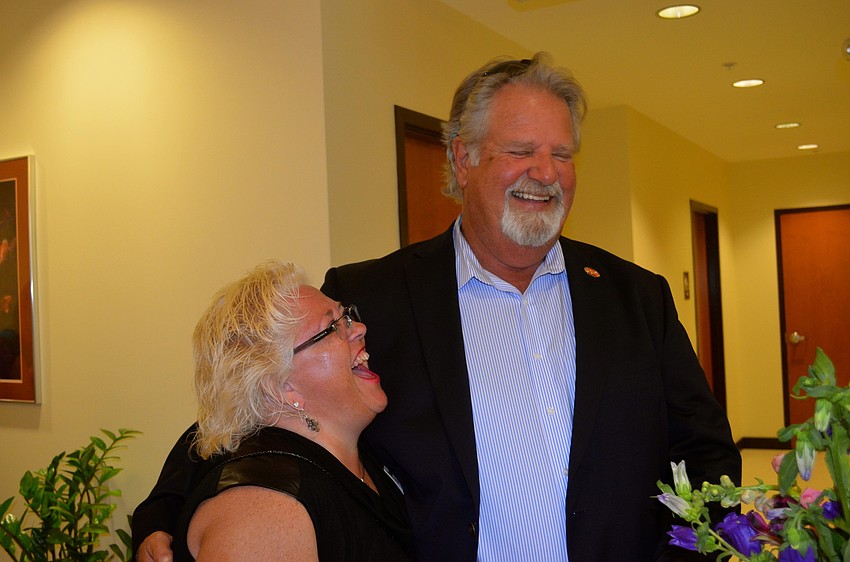 School Board Chairwoman Julie Aranibar shares laughs with John Barnott.