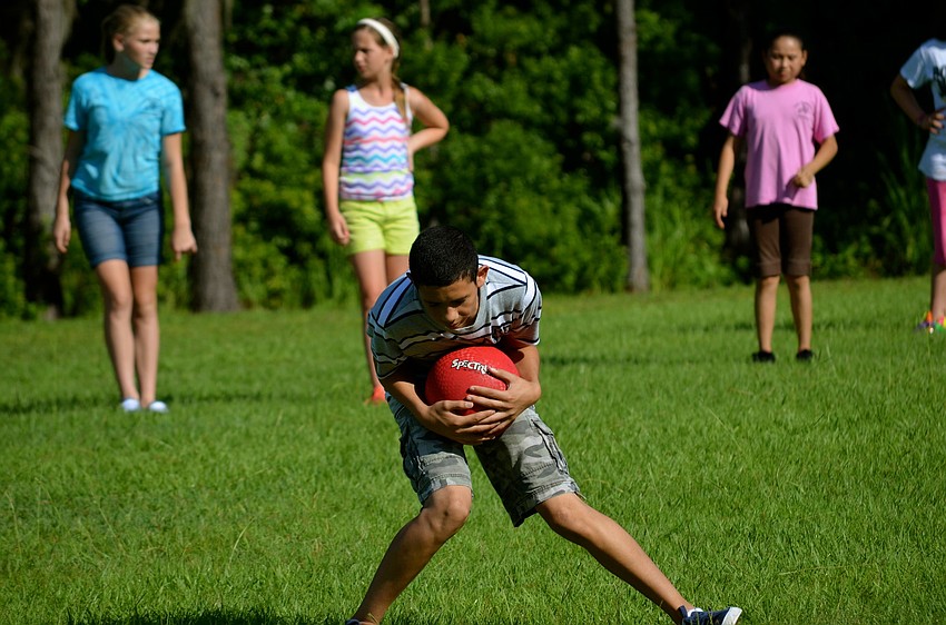 Twelve-year-old Armando Flores catches the ball.