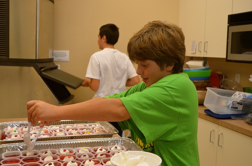 Enzo Cashi-Orsini puts the final touches on the Jell-O snacks.