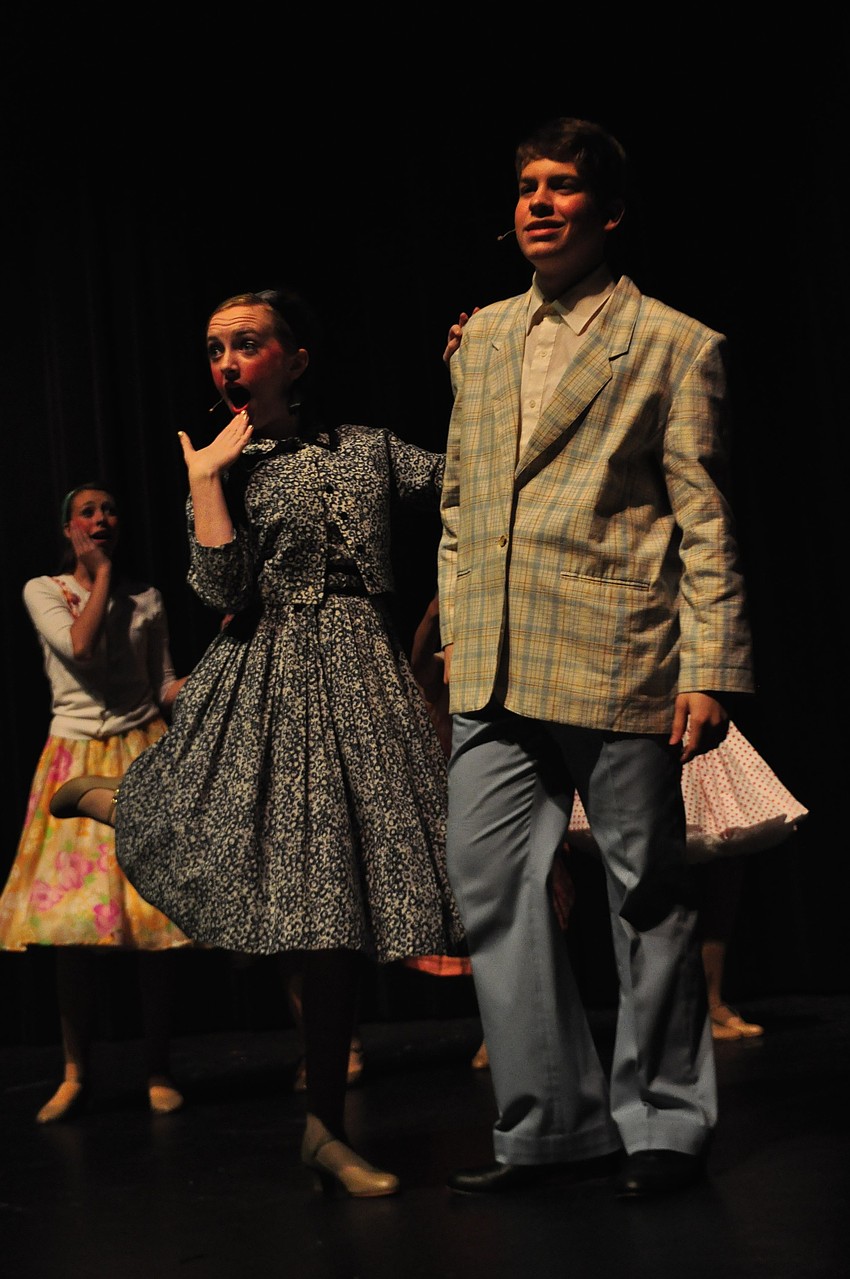 Laura McKenna, as Amber Von Tussle, walks with Jackson Helwege, as Link Larkin.