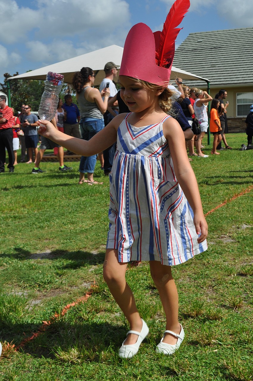 Kylie Didion wears a dress to match the occasion.