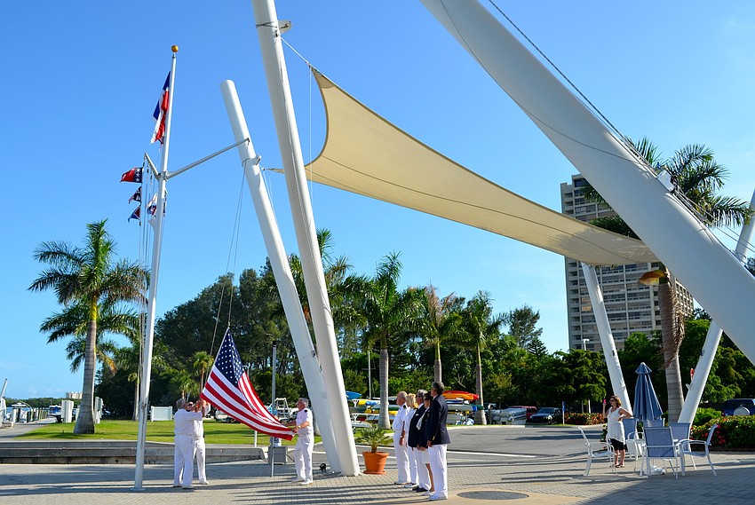 Members of the Sarasota Yacht Club watch the Sundowner Ceremony before enjoying a Fourth of July dinner.
